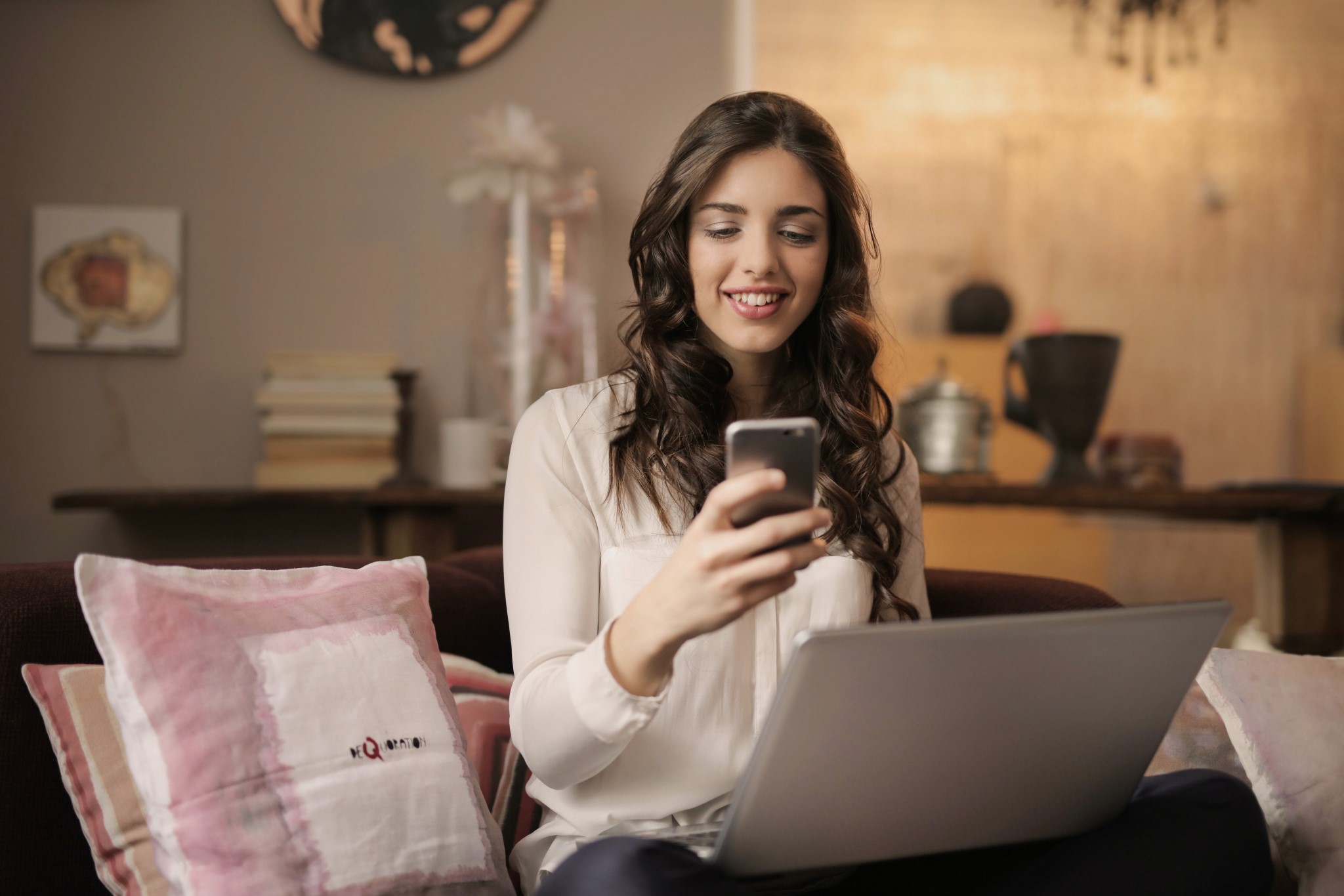 young woman looking with a smile at her phone
