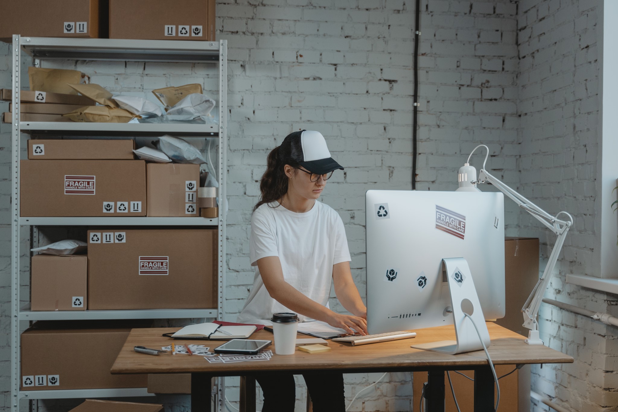 Young woman working on the computer in a warehouse